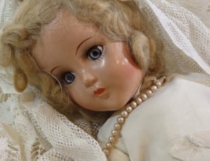 baby doll in beige dress thumbnail