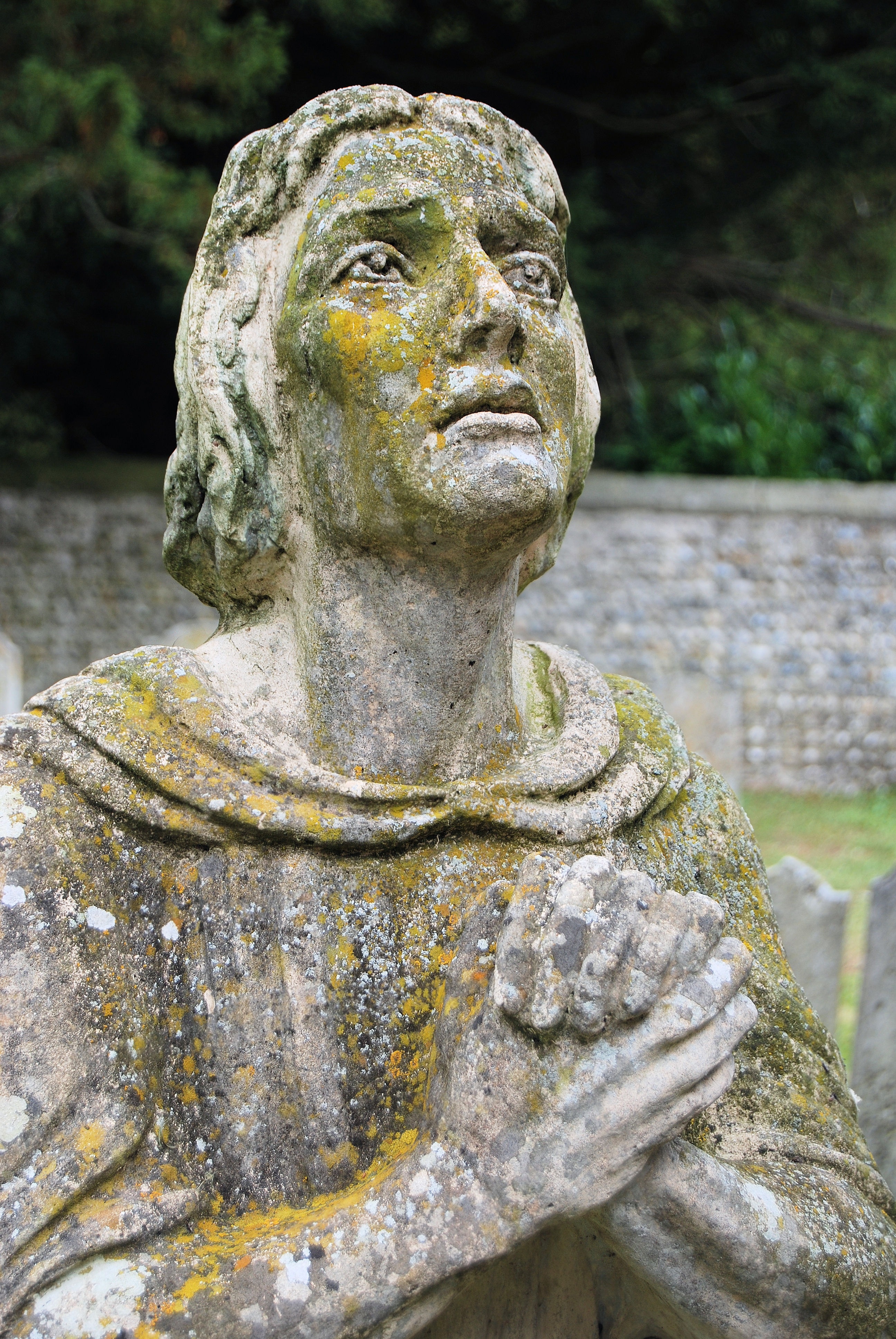 person doing prayer concrete statue