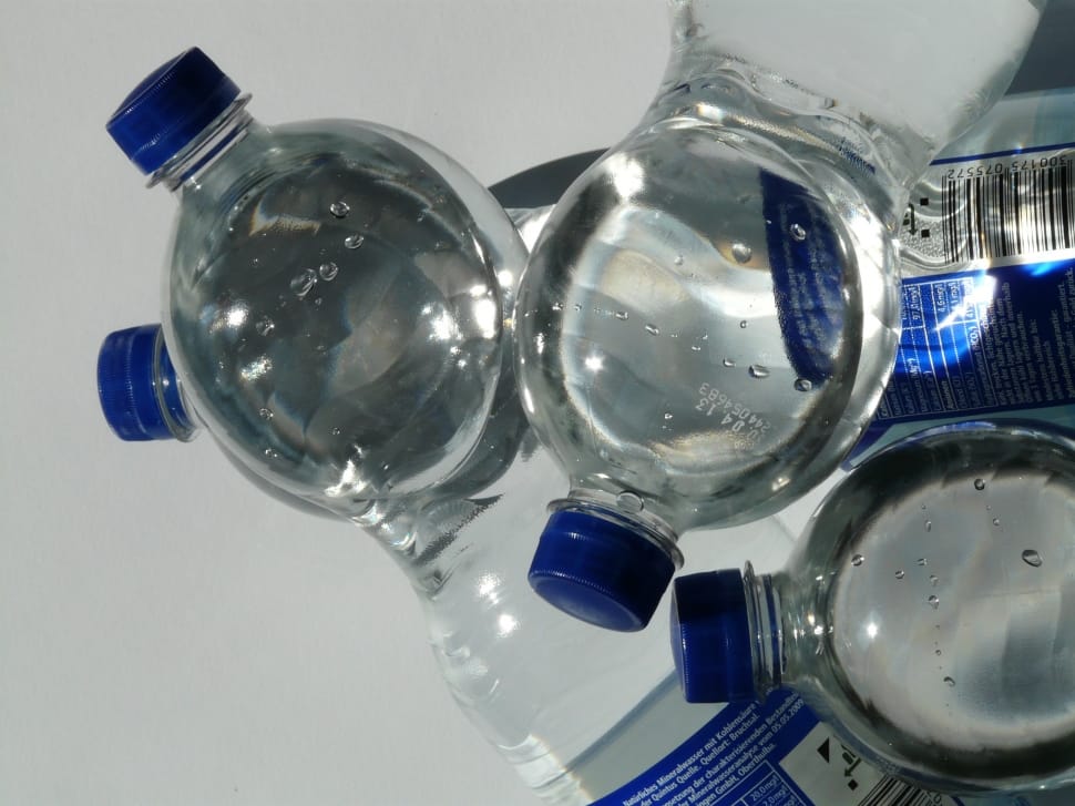four plastic bottles on white surface preview