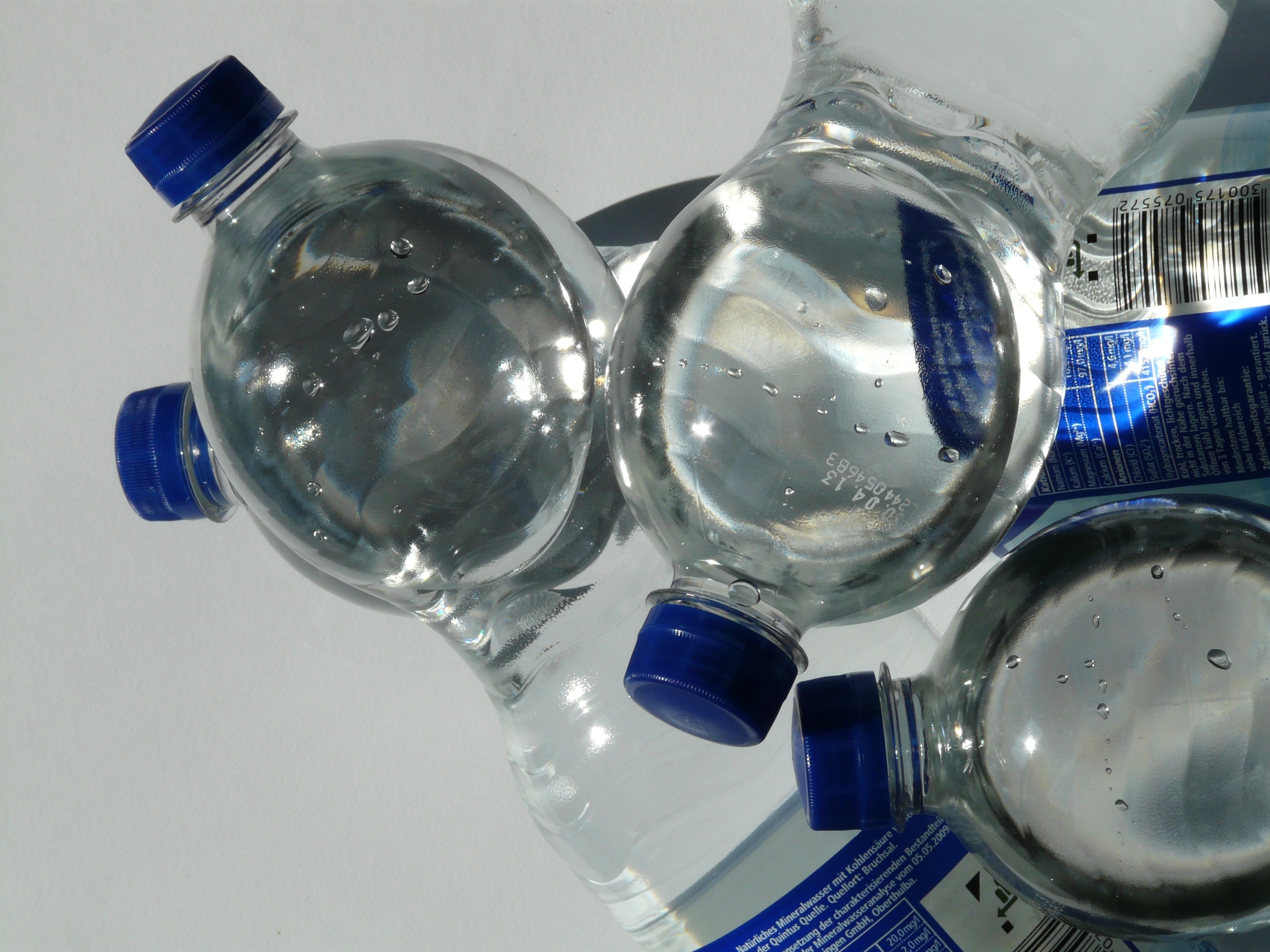 four plastic bottles on white surface