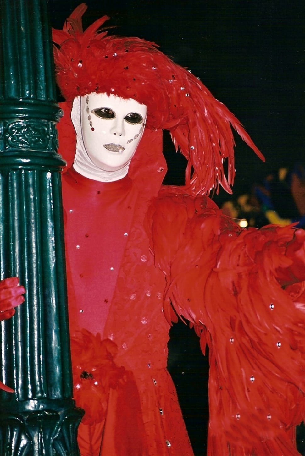 person wearing red feathered costume preview