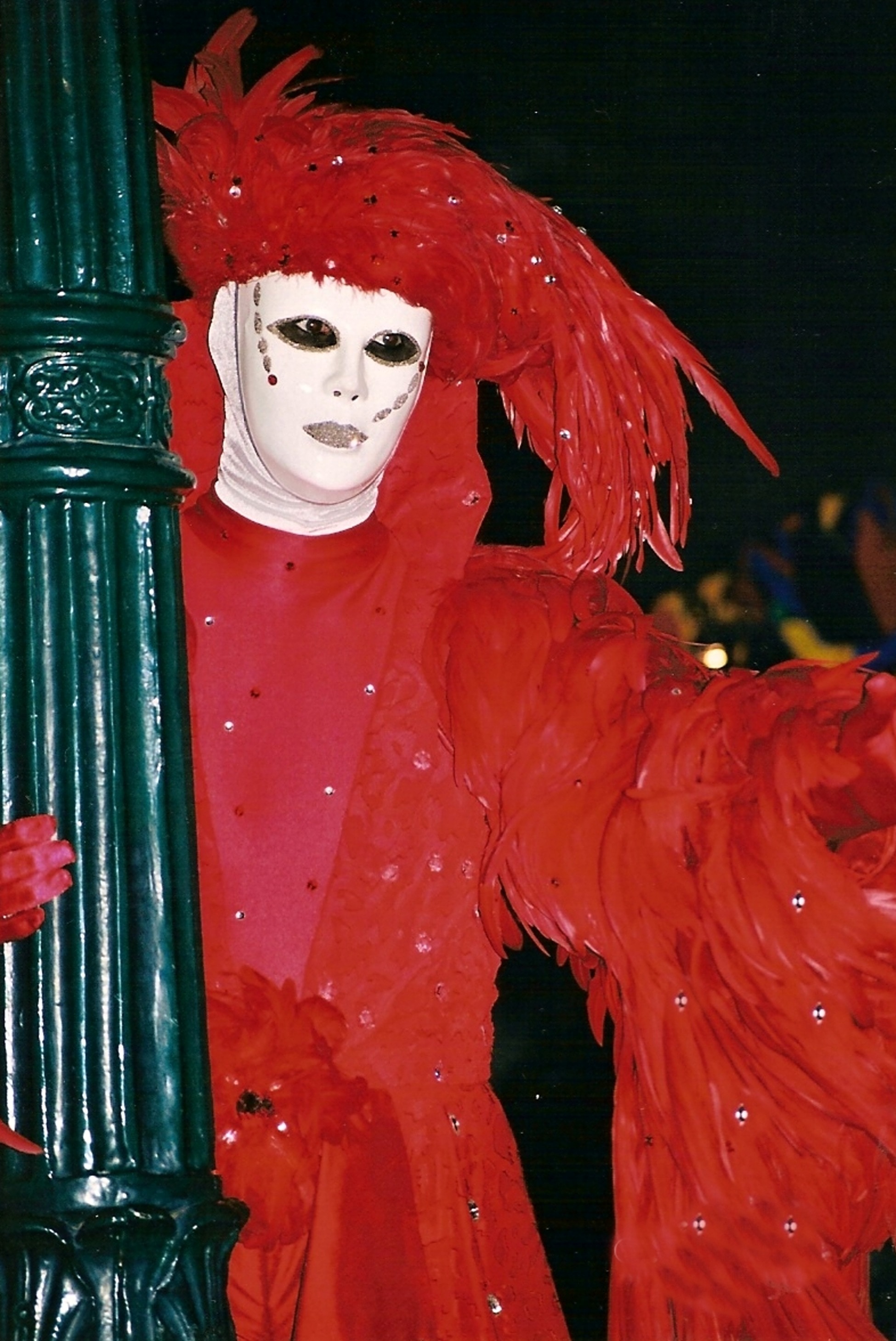 person wearing red feathered costume