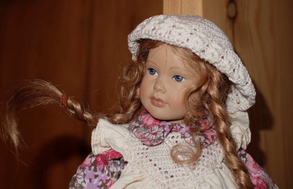 girl in white and pink floral dress with white knit cap doll preview