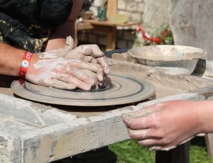 person making a vase using clay thumbnail