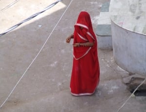 woman in red dress standing in the high way thumbnail