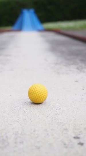 selective photography of yellow ball on pathway thumbnail