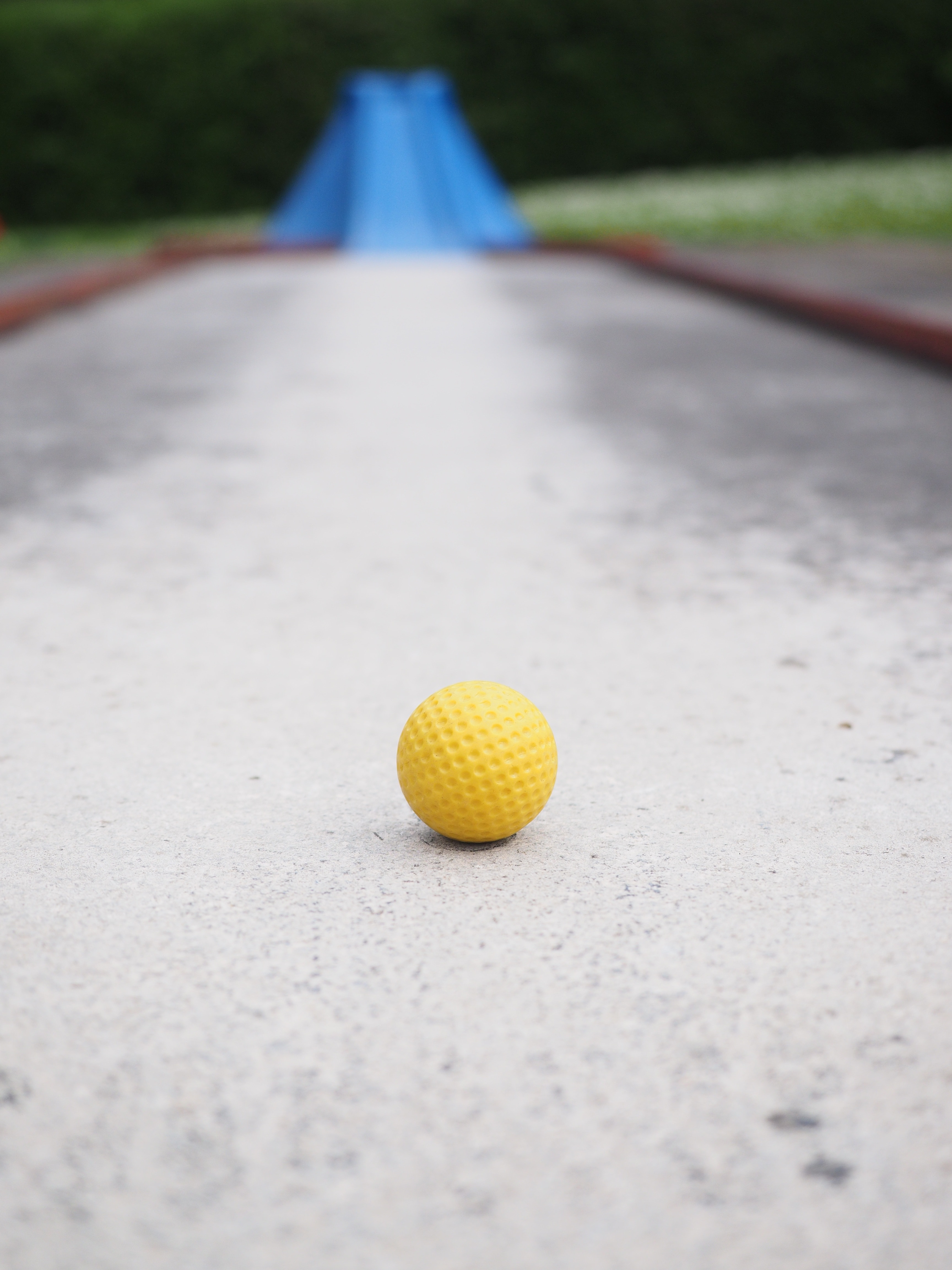 selective photography of yellow ball on pathway
