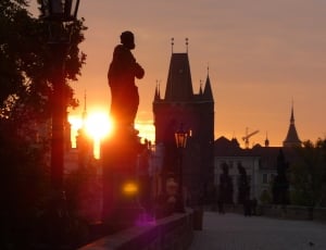 golden hour silhouette of statue photography thumbnail