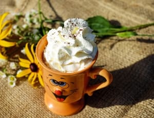brown footed cup filled with cream whip thumbnail
