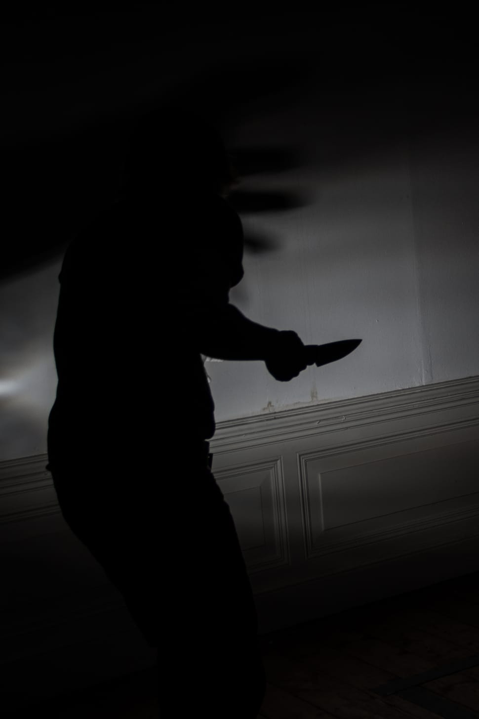 shadow of person holding knife preview