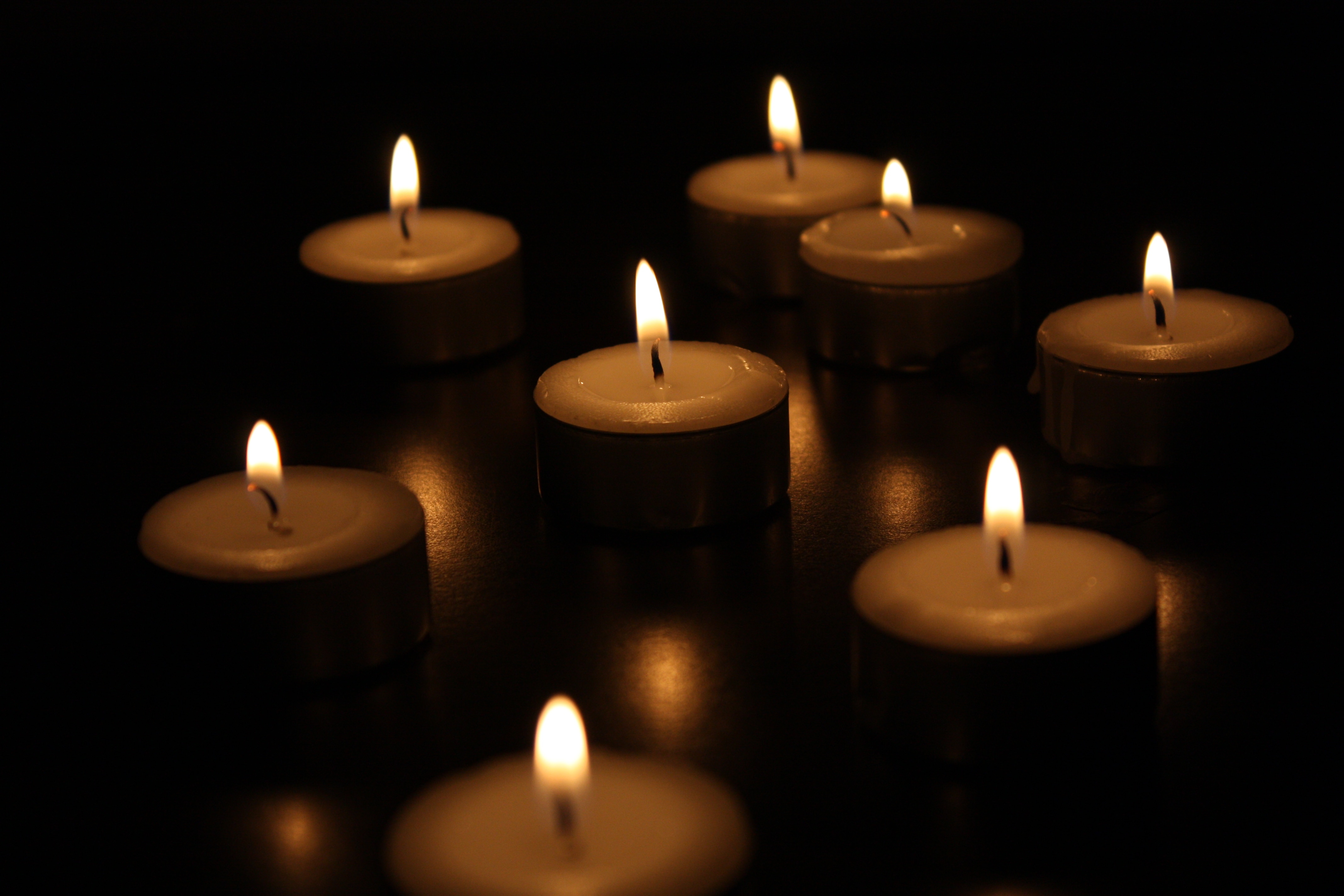 lighted scented candles on dark room