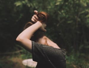woman in grey t shirt holding hair at daytime thumbnail
