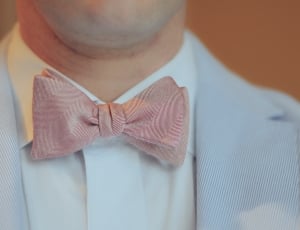 man in grey suit jacket and bow-tie thumbnail