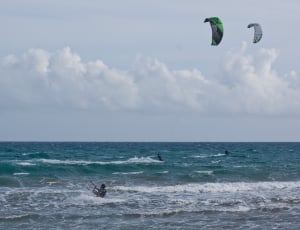 person flying kite on water at daytime thumbnail