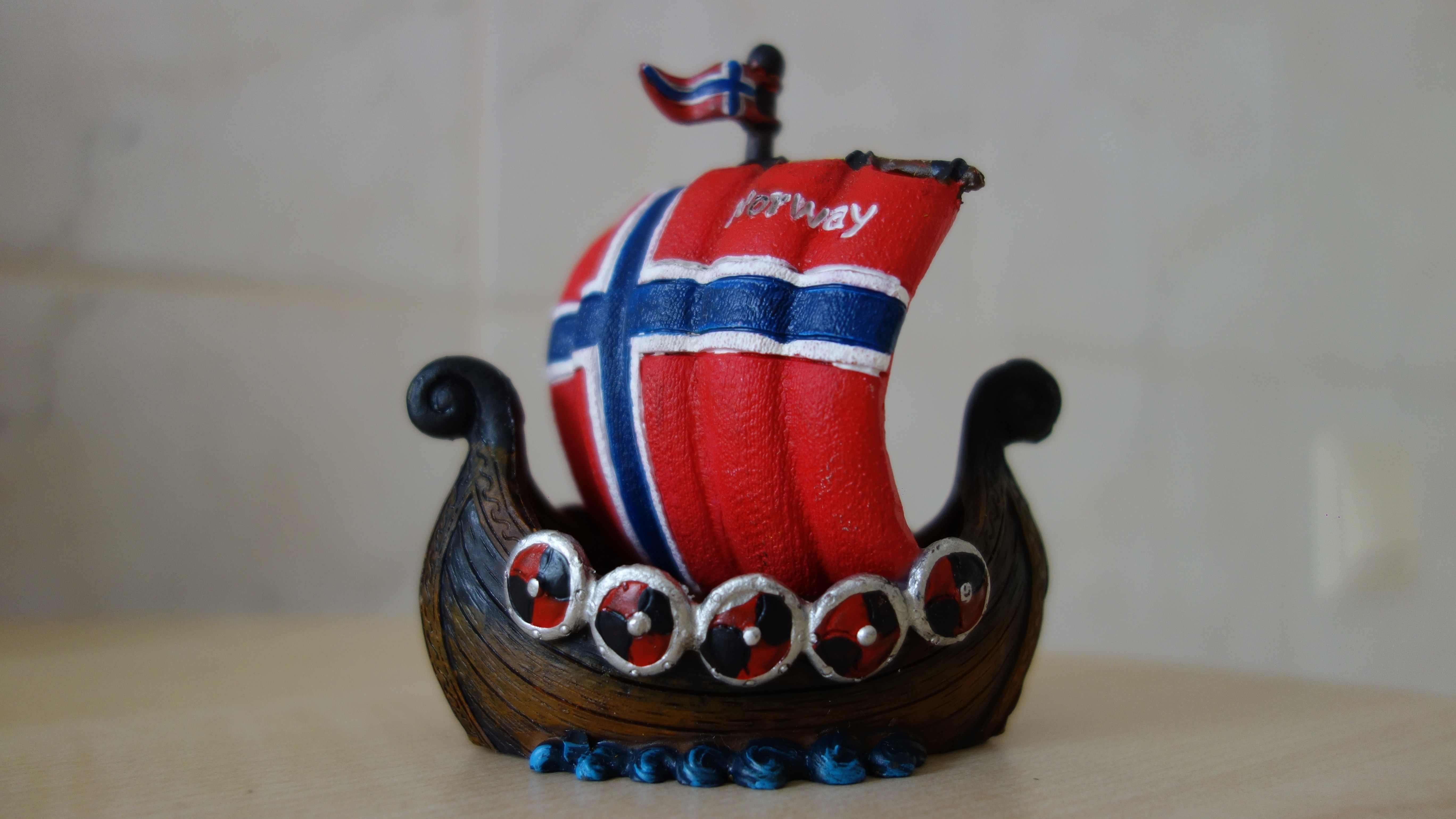 brown red blue and white galleon ship figurine