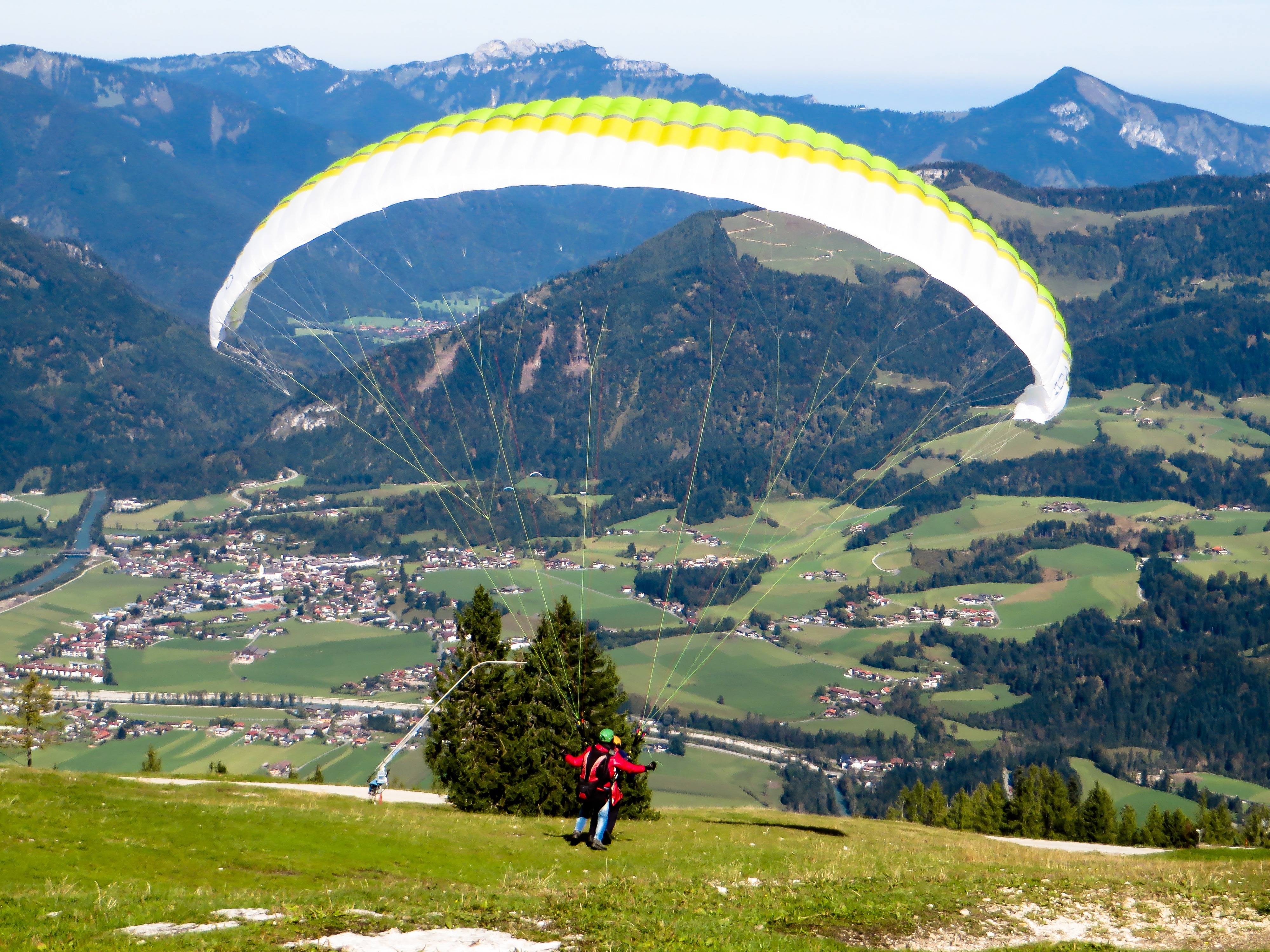 white and green and yellow paragliding