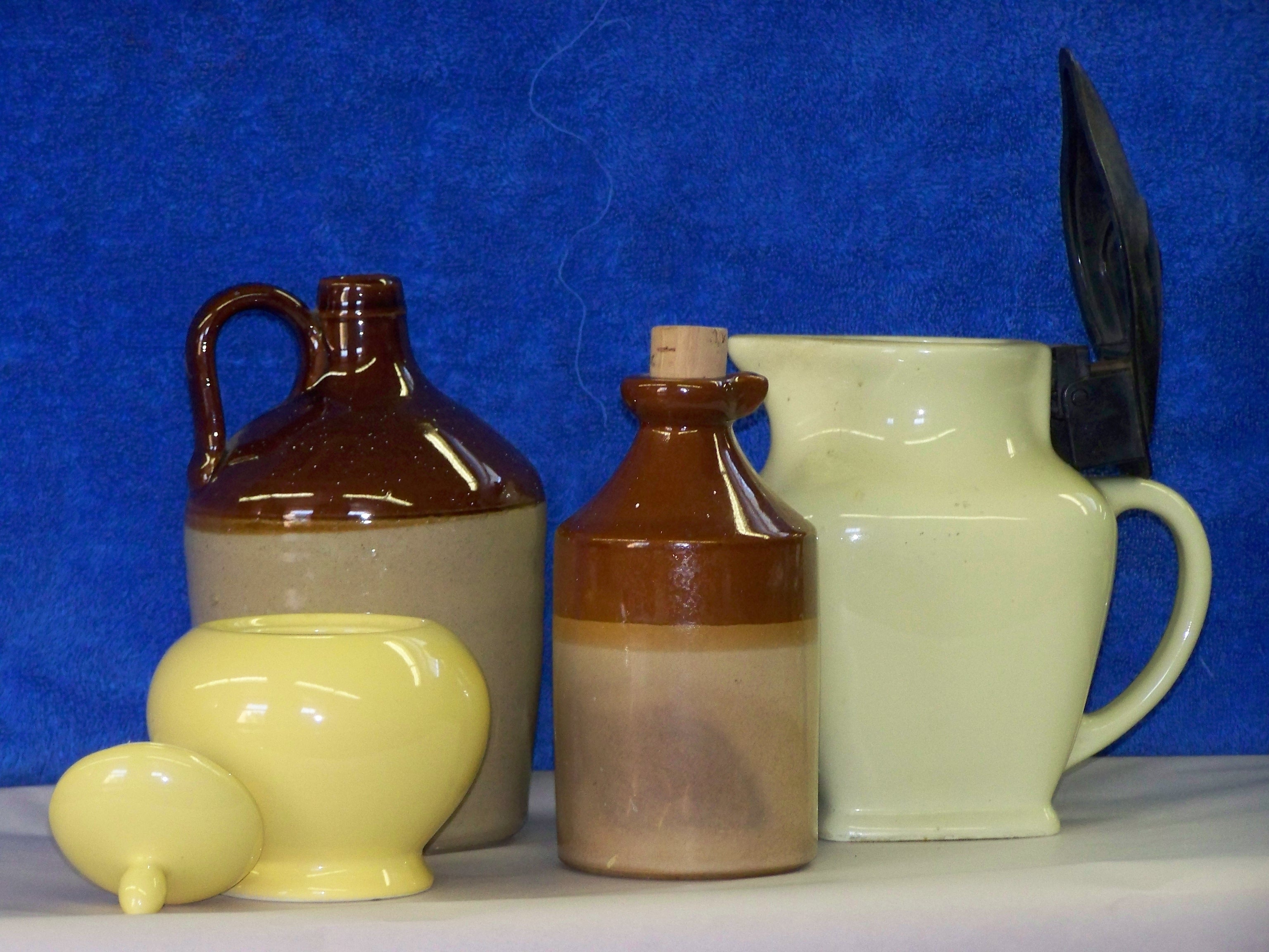 white and brown ceramic jug