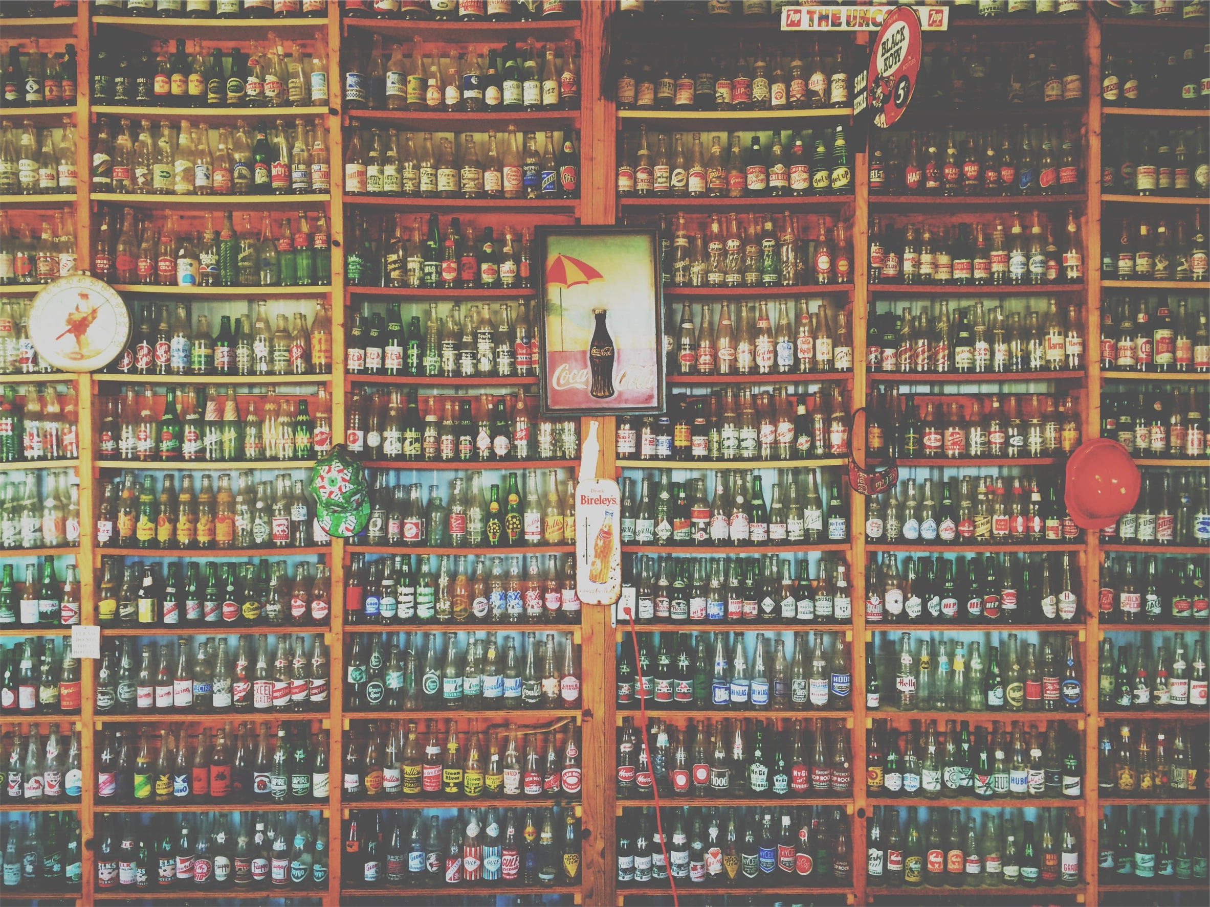 liquor bottle lot in brown wooden shelf
