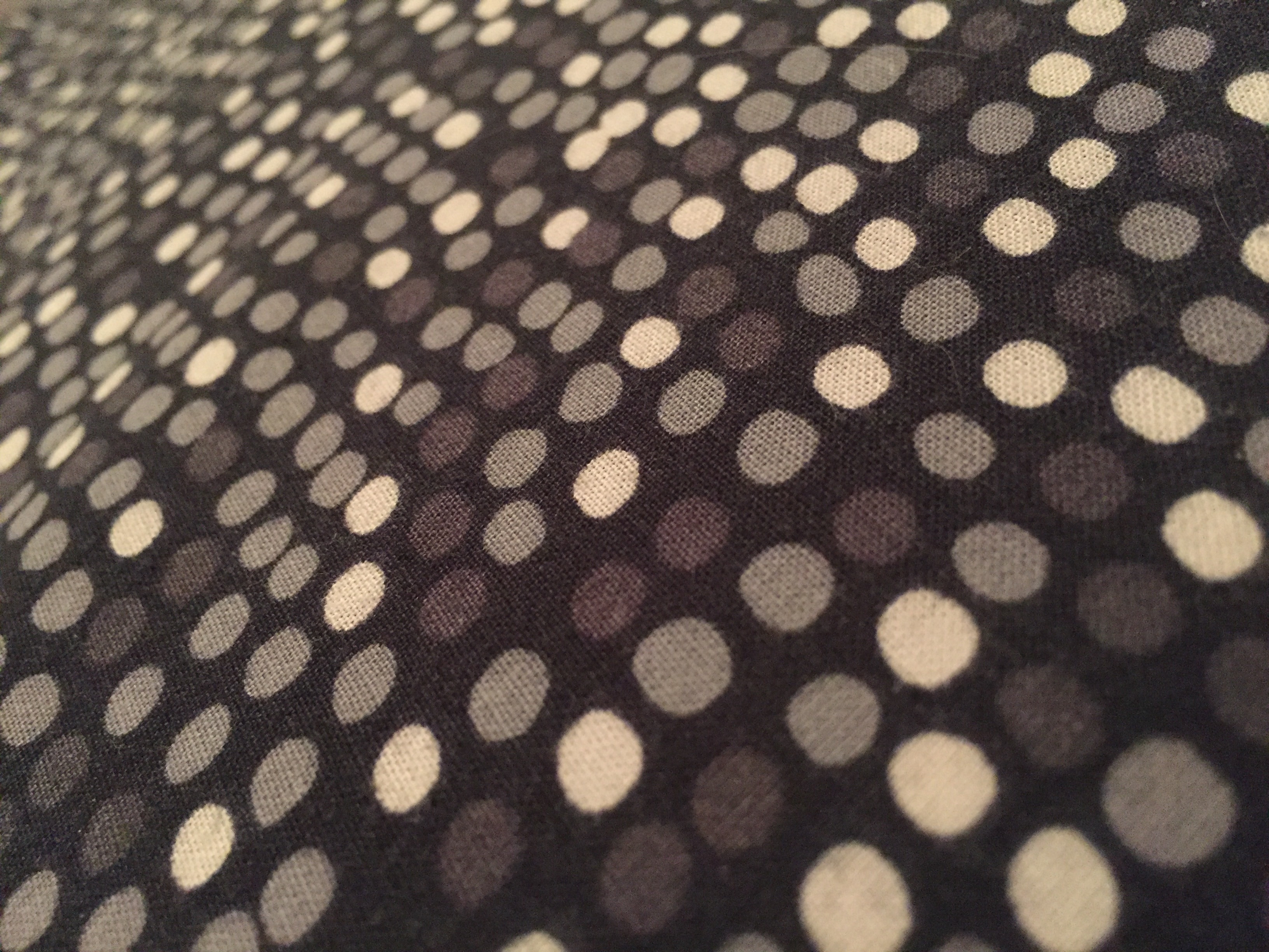 white and black polka dot textile
