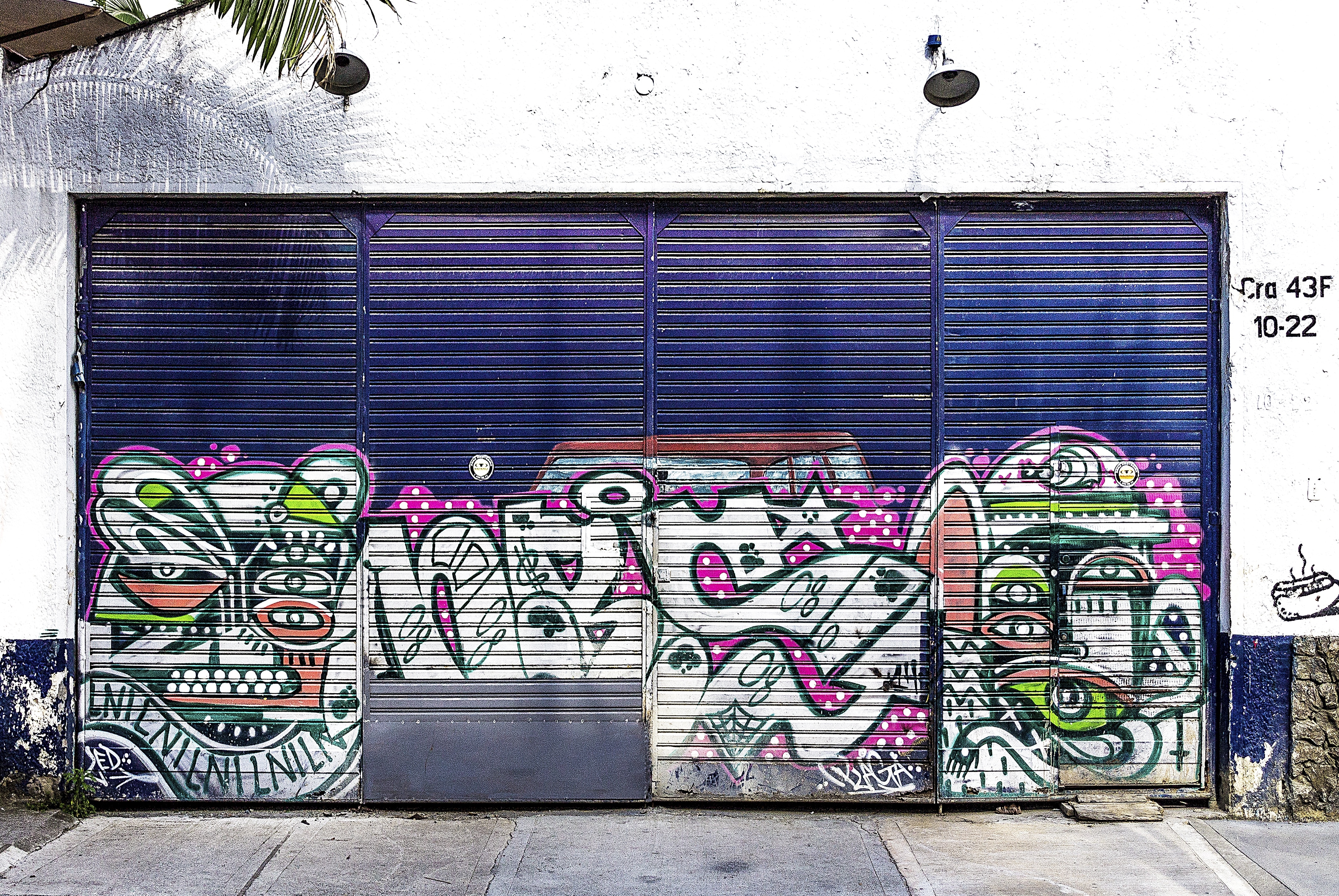blue and multicolored graffiti printed roll up garage door