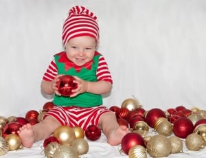 baby holding red bauble thumbnail