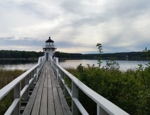 lighthouse beside body of water thumbnail