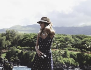 woman wearing hat and sweetheart dress during daytime thumbnail