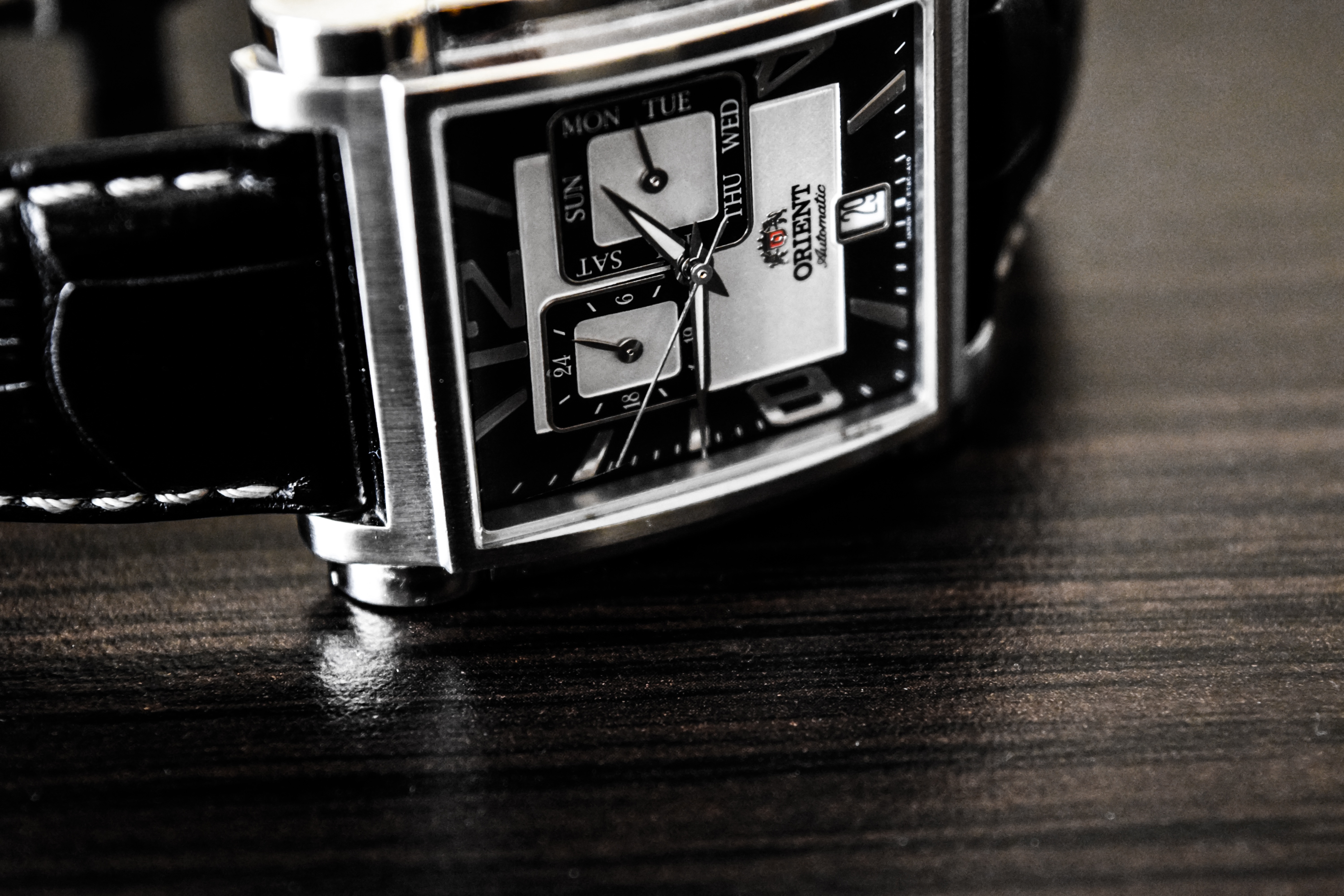 black strap silver black dial face orient watch