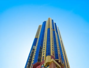 low angle view of blue and yellow commercial building thumbnail