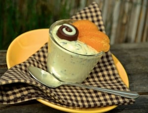 dessert on clear glass cup with stainless steel spoon thumbnail