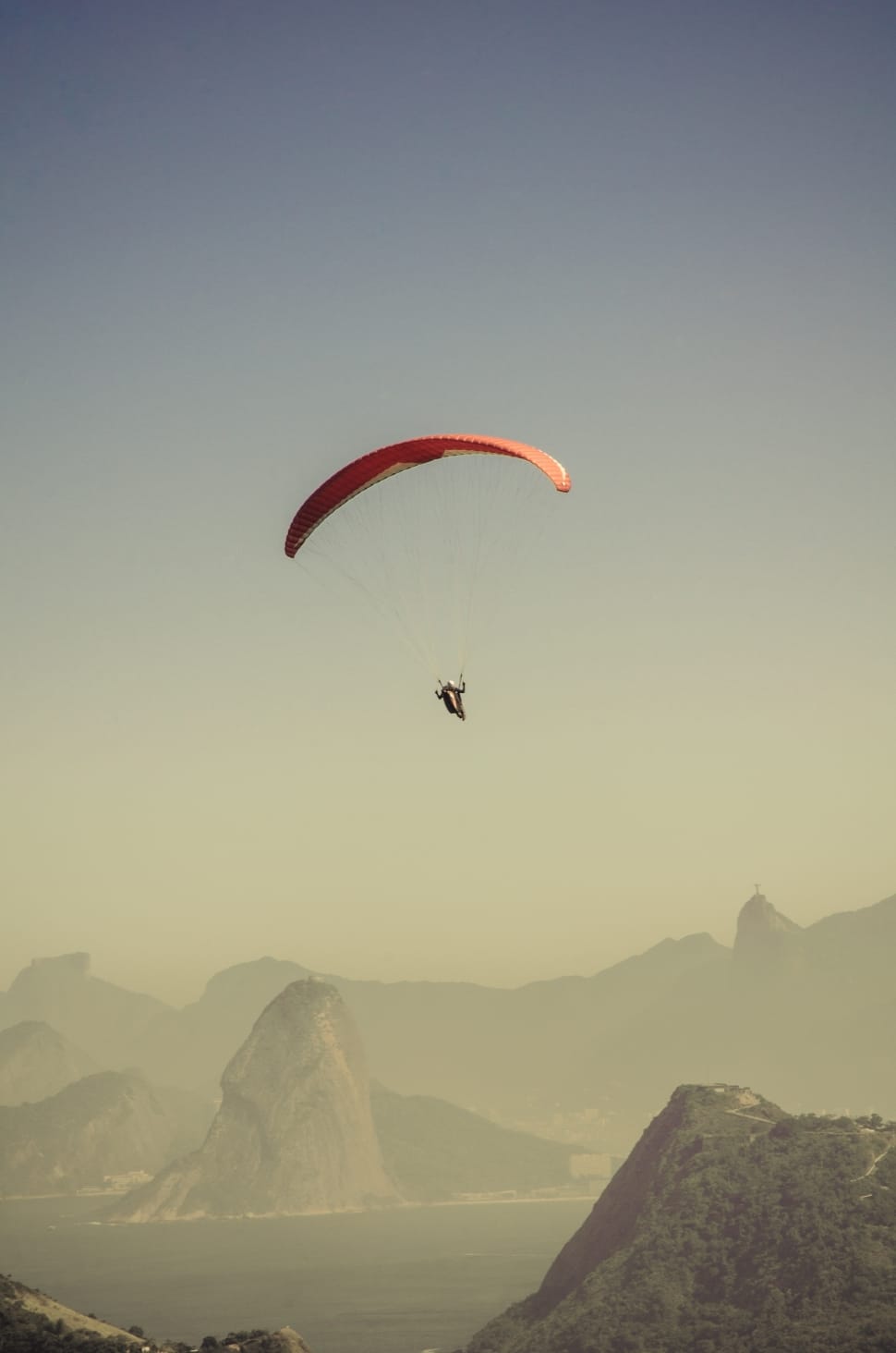person paragliding during daytime preview