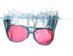 red lens black framed sunglasses on water thumbnail