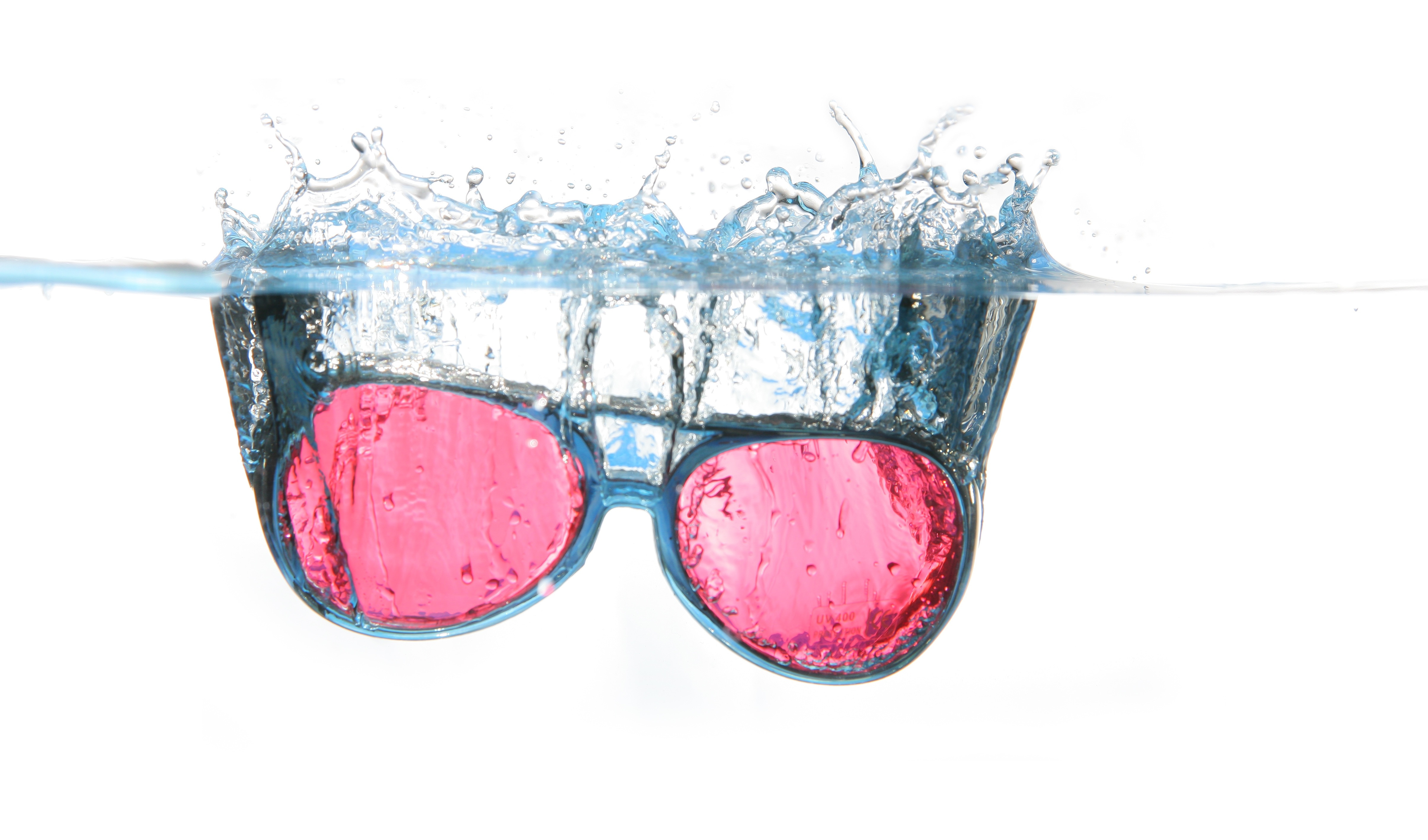red lens black framed sunglasses on water