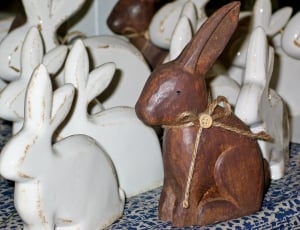 white and brown wooden rabbit sculpture lot thumbnail
