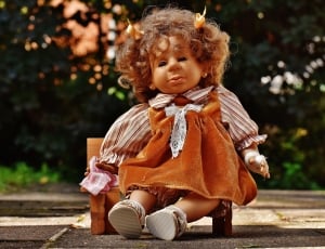girl in brown long sleeve dress doll thumbnail