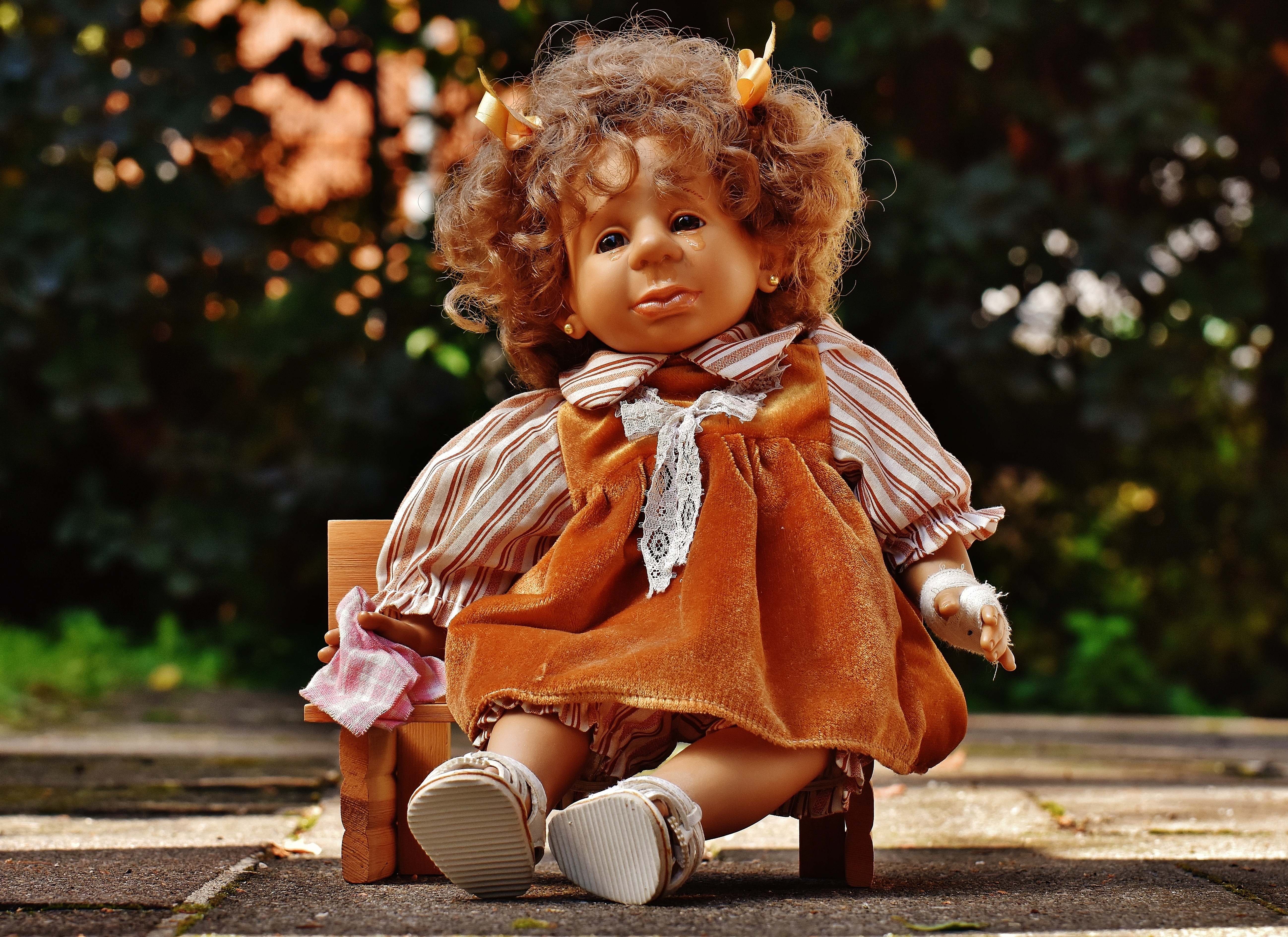 girl in brown long sleeve dress doll