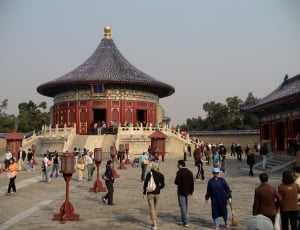 people walking towards brown and black temple during daytime thumbnail