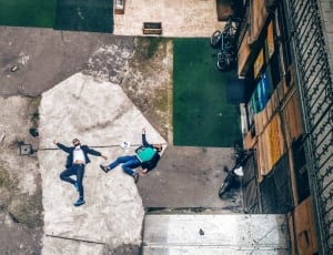 two man lying down on concrete path thumbnail