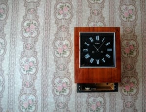 brown and black wooden wall clock thumbnail