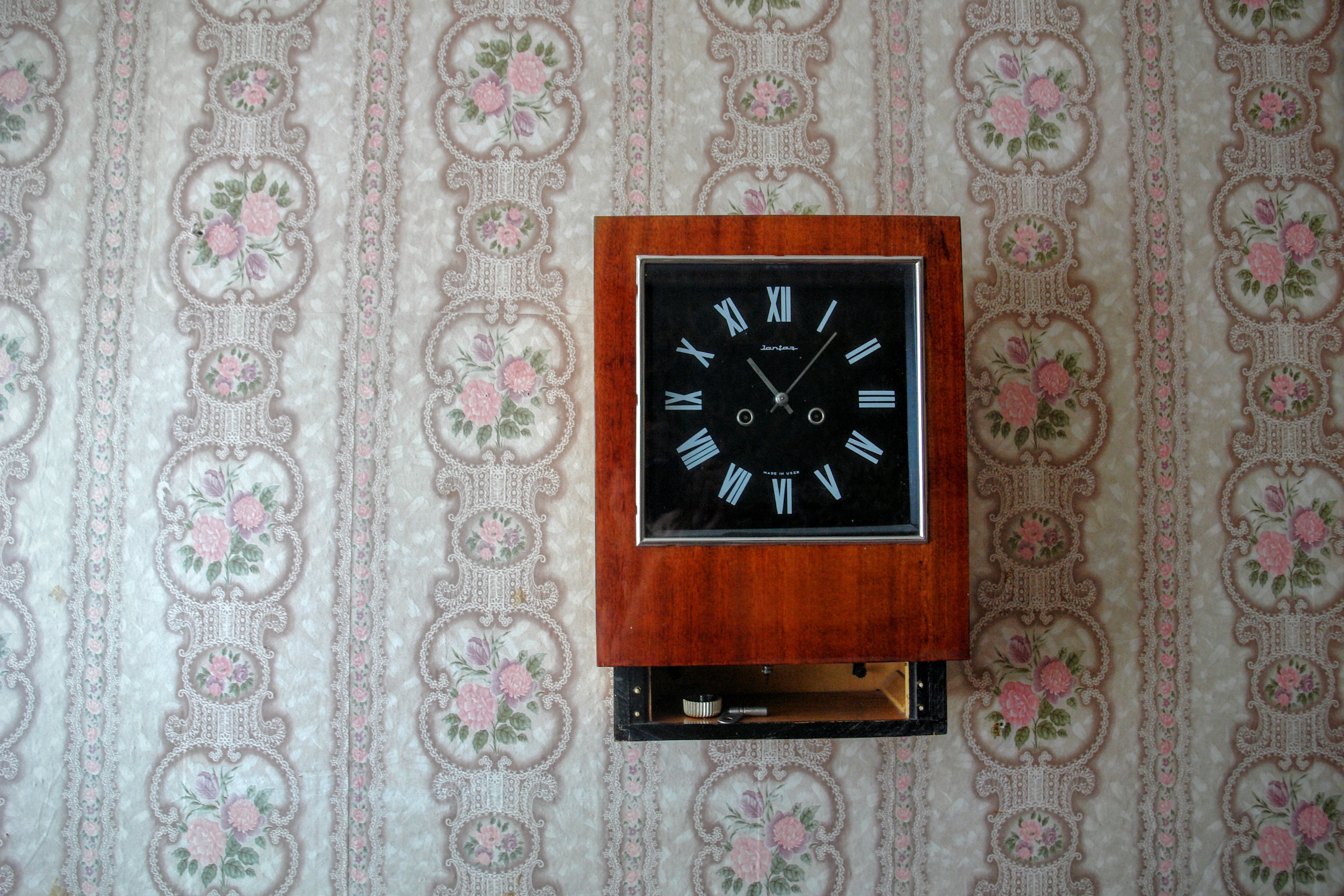 brown and black wooden wall clock