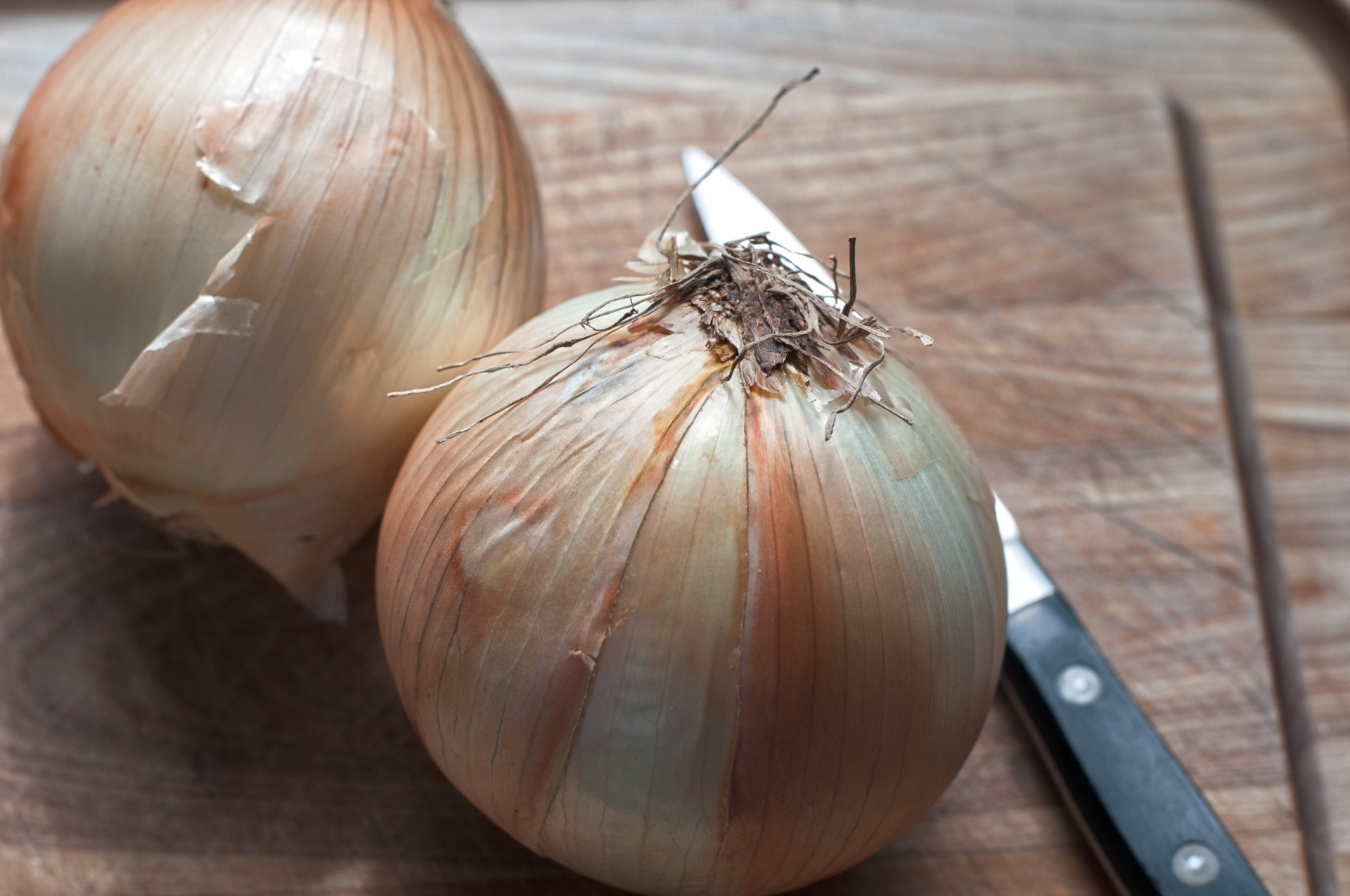 white onions on top of chopping board
