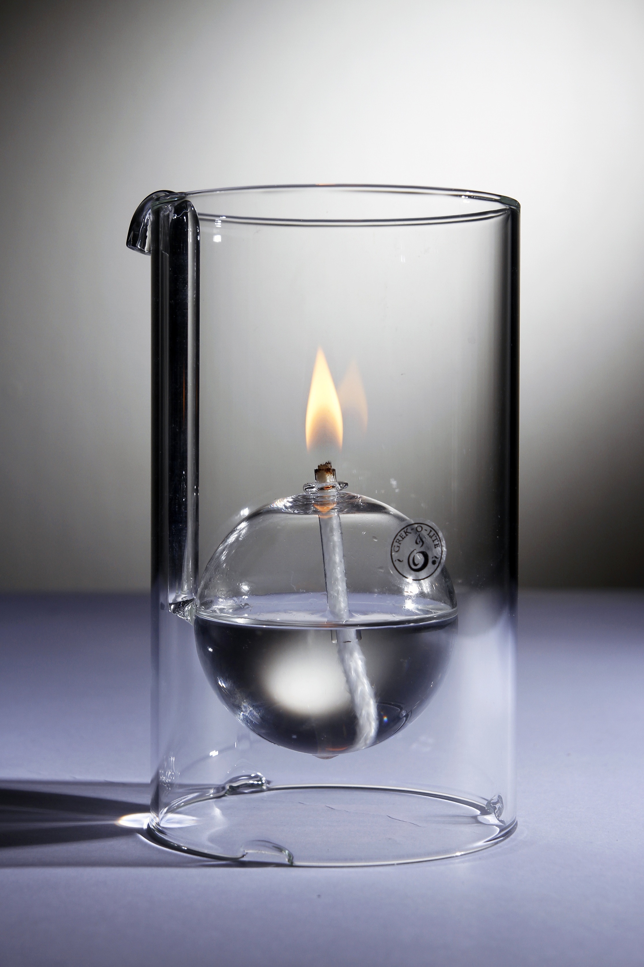 close up photo of cylindrical glass with fire