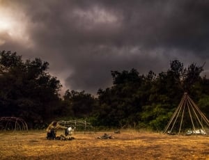 photo of a man and dog camping on gloomy day thumbnail