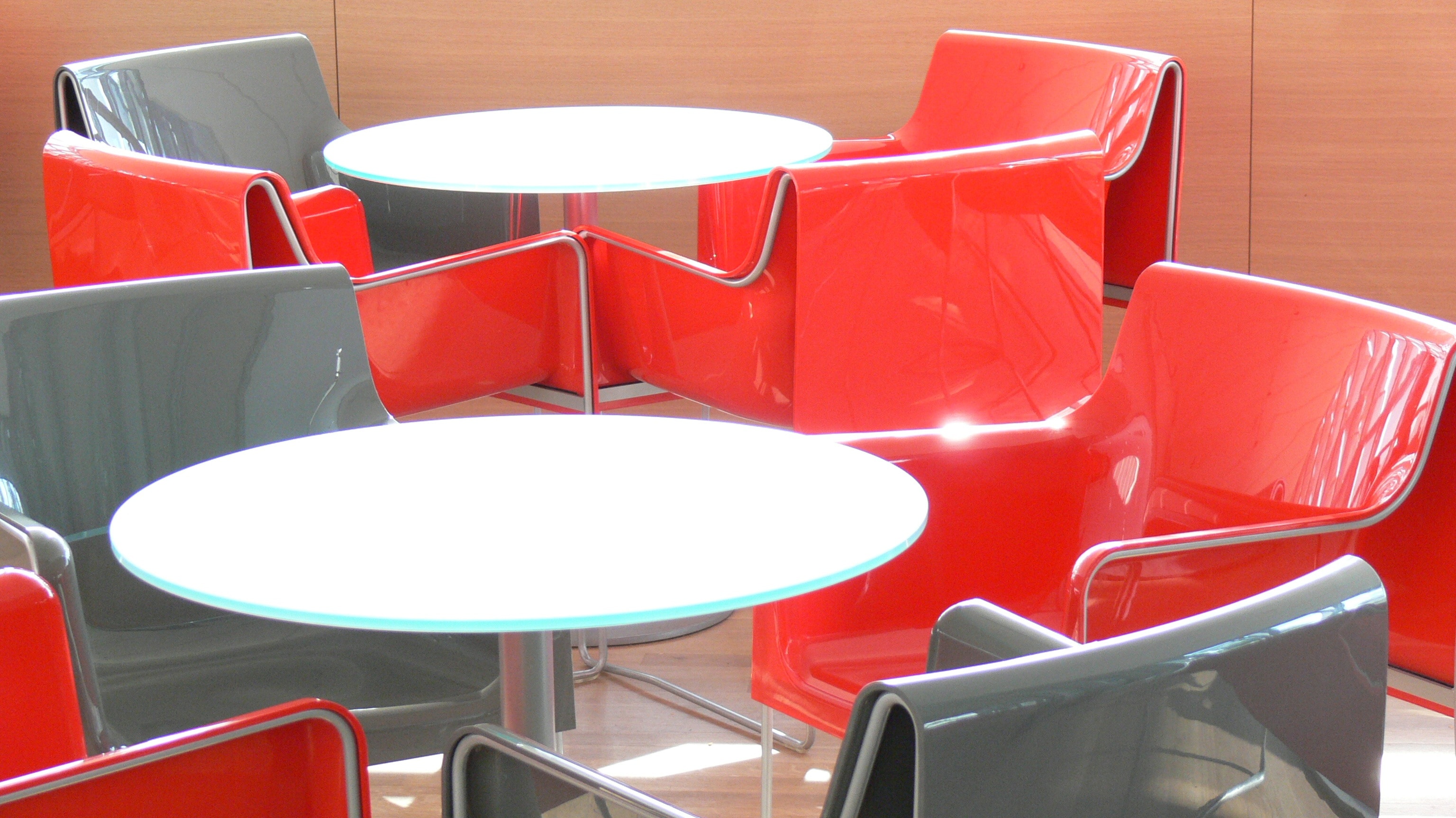 stainless steel base white table top and 4 red gray metal chairs