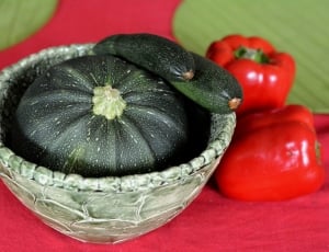 green and white round ceramic bowl with three vegetables on top thumbnail