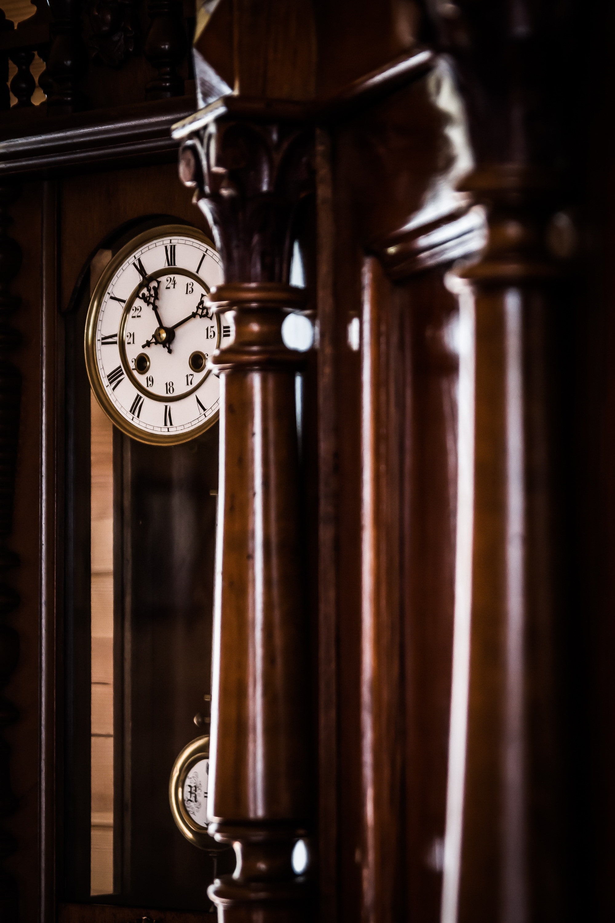 brown wooden grandfathers clock second person view photography