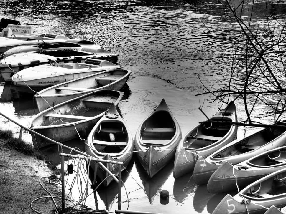 grayscale photograph of canoe lot preview