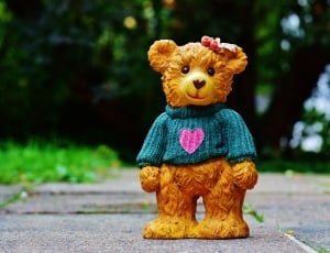 brown bear figurine on land thumbnail
