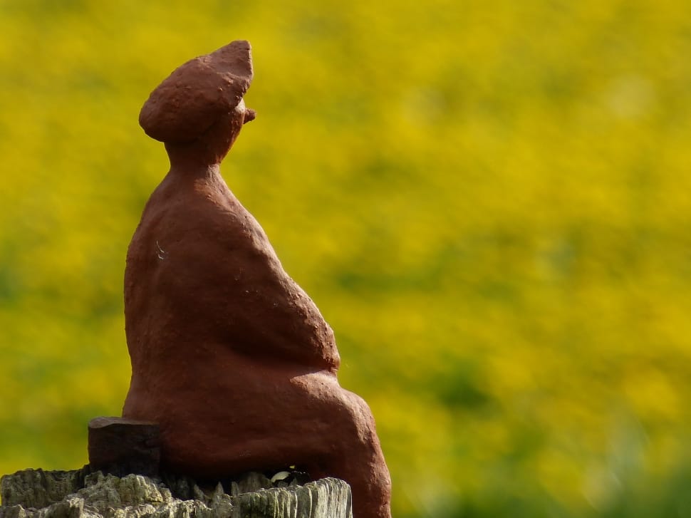 ceramic figurine of man sitting preview