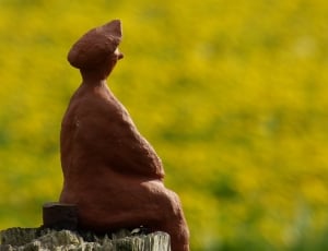 ceramic figurine of man sitting thumbnail